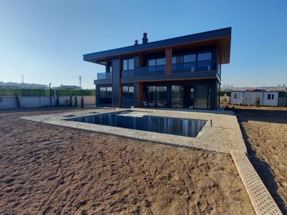 Private heated swimming pool and contemporary exterior of the exclusive luxury villa in Gölbaşı, Ankara.
