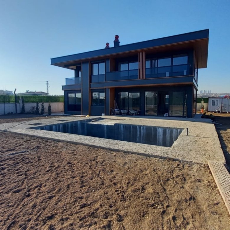 Private heated swimming pool and contemporary exterior of the exclusive luxury villa in Gölbaşı, Ankara.