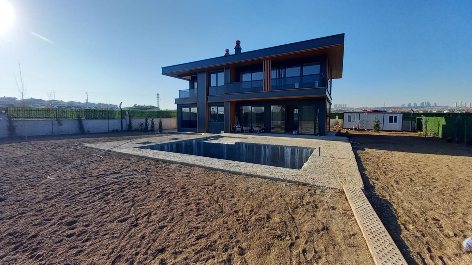 Private heated swimming pool and contemporary exterior of the exclusive luxury villa in Gölbaşı, Ankara.